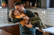 © NDABCREATIVITY - Happy loving daddy and affectionate boy playing, laughing having fun at home. Family leisure concept