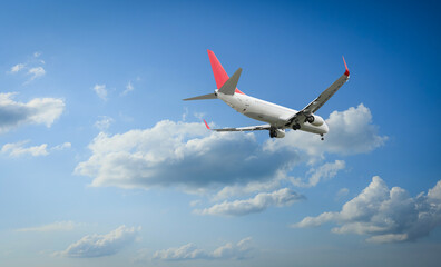 Wall Mural - airplane flying in beautiful blue sky with clouds