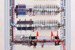 © Larisa - View from the back of the electrical panel. Connection of electronic modules using copper electrical wires. Fixed with plastic ties.