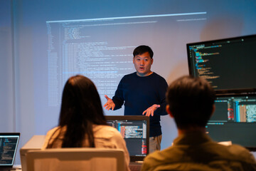 Asian software engineer or programmer team working late in development office,problem solving or algorithm of ai assistant helping for work.software developer,digital technology security concept