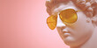 © DaniLana - Close-up of a translucent marble antique sculpture wearing modern glasses. Juxtaposition of classical art and contemporary style, pastel tones, clean backdrop.