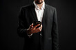 © fotofabrika - Professional man in formal attire checking smartphone in dimly lit environment