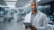 © pixs4u - A professional male scientist in a lab coat holds a tablet in a modern laboratory, showcasing innovation and technology in science.