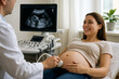 © thodonal - Pregnant woman smiling during ultrasound examination in clinic