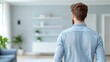© Paisan - Amazing Opportunities Concept. Stylish Young Man Observing Modern Living Room Interior with Minimalist Design