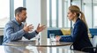 © Khan - A man and a woman in a business meeting, discussing in an office setting.