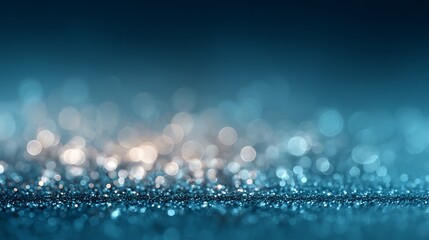 Abstract blue glitter sparkle background with blurred bokeh effect for festive designs