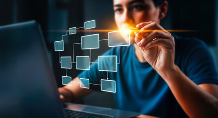 A person interacts with a glowing digital flowchart on a laptop screen