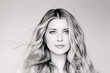 © Anna Studio - Natural beauty and hair care, blonde woman with blue eyes and elegant flowing waves, calm expression, classic elegant monochrome