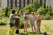 © pressmaster - Group of multiethnic adults and teenager gardening outdoors, planting young tree together in urban park, holding sapling and gardening tools, collaborating on community project