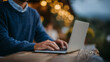 © Maksym - Freelance copywriter sitting at rustic wood table near cafÃ© bar, laptop open, fingers mid-type, creative energy in the air, natural textures and moody lighting create ideal atmosph