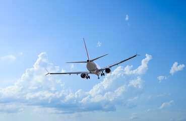 Wall Mural - airplane flying in beautiful blue sky with clouds