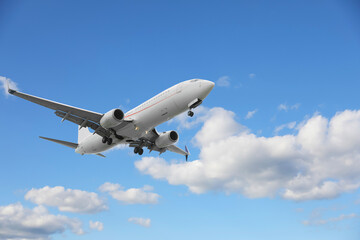 Wall Mural - airplane flying in beautiful blue sky with clouds