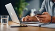 © Cre-AI-Tor  - Businessman Working with Laptop and Smartphone at Desk