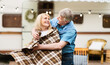 © Prostock-studio - Happy senior man putting warm plaid on his beloved wife's shoulders at camping site. Panorama