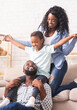 © Prostock-studio - Happy family lifestyle concept. Afro mother, father and their little daughter having fun at home together.