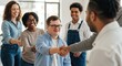© NN AI - Man with down syndrome shaking hands with colleague in modern office surrounded by diverse team. Happy person with glasses celebrating workplace inclusion. Disability acceptance concept