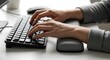 © Airwj - Close-up of a person's hands typing on a computer keyboard with an ergonomic wrist rest, focused on the action of digital communication and work.