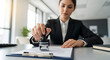 © AhmadMuslih - Professional woman stamping a document for official approval at her desk