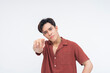 © Mdv Edwards - A furious young Asian man pointing aggressively at the camera with a mad expression. Isolated on a white background.