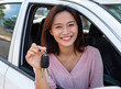 © Ganesha88 - Happy smiling woman holding car keys sitting inside white vehicle enjoying moment