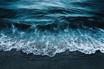 ocean waves crashing on a dark beach