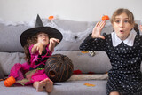 Funny kids acting scary in Halloween costumes at home