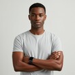 © lina - Confident young man with arms crossed wearing a gray t-shirt.
