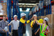 © Wanwajee - Inclusive logistics team standing in aisle. Represents strong corporate culture, safety, and collaboration.