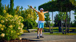 © master1305 - Older man stretching arms in park under morning sun in yellow shirt and shorts. Concept of morning routine, flexibility, healthy aging, outdoor wellness, mental clarity.