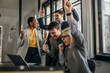 © La Famiglia - Excited business team celebrating success in the office