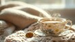 © Bimha - Cozy teacup steaming on a knitted blanket by a window
