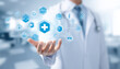 © 打算 朱 - Medical professional presenting digital health icons, symbolizing advanced healthcare technology.