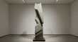 © hatkadigital - Abstract stone sculpture displayed in a minimalist art gallery with neutral walls and lighting fixtures