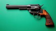 © red_orange_stock - Classic revolver displayed on vibrant green background