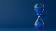 © photo for everything - Hourglass with Blue Sand: Capturing the Ephemeral Nature of Time. The clock counts down, marking the passage of moments. Time is fleeting. Plan today!