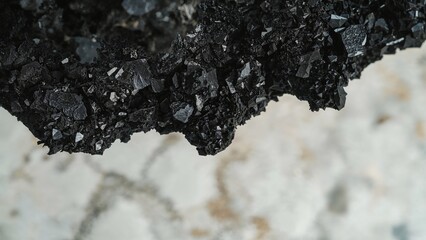 Wall Mural - close-up of black mineral rock fragments. dark abstract backdrop with soft focus. bird's eye view.
