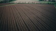 © TheWaterMeloonProjec - Birdâ€™s-eye perspective of furrowed farmland arranged for planting and flourishing with healthy crops on fertile ground