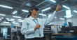 © Gorodenkoff - Portrait of a Female Engineer Using a Mixed Reality Headset and Gesturing with Her Hands in the Air. Technician Working with Futuristic Equipment. Arc Footage in an Industrial Factory Environment
