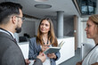 © Migma_Agency - Businesswoman holding notebook talking to colleagues during coffee break