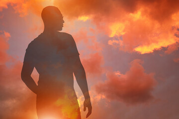 Wall Mural - hope. silhouette of man under beautiful sky at sunset, double exposure