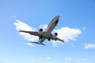 Wall Mural - airplane flying in beautiful blue sky with clouds