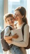 © olga_demina - Smiling mother is embracing her young son, who is holding school books and wearing a backpack, standing next to a bright window, ready for his first day of school