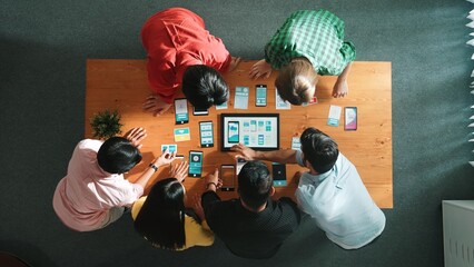 Wall Mural - top view of software developer team looking ux ui design for mobile phone interface from tablet whil