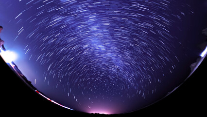 Wall Mural - universe star trails of polaris north star fisheye panorama in purple sky astrophotography
