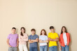 © New Africa - Group of teenagers near beige wall indoors. Space for text