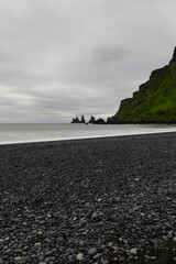 Wall Mural - Reynisdrangar rock formation viewed from the black sand beach shore.