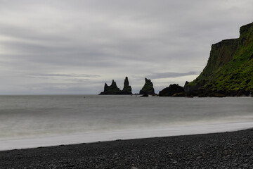 Wall Mural - Overcast day view over Reynisdrangar rock formation, Iceland.