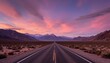 © Pete - Endless asphalt road through desert valley towards mountains under dramatic sunset sky. Scenic travel backdrop with vast arid landscape and wide open horizon, evoking freedom and adventure.