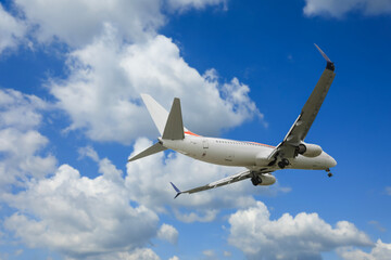 Wall Mural - airplane flying in beautiful blue sky with clouds